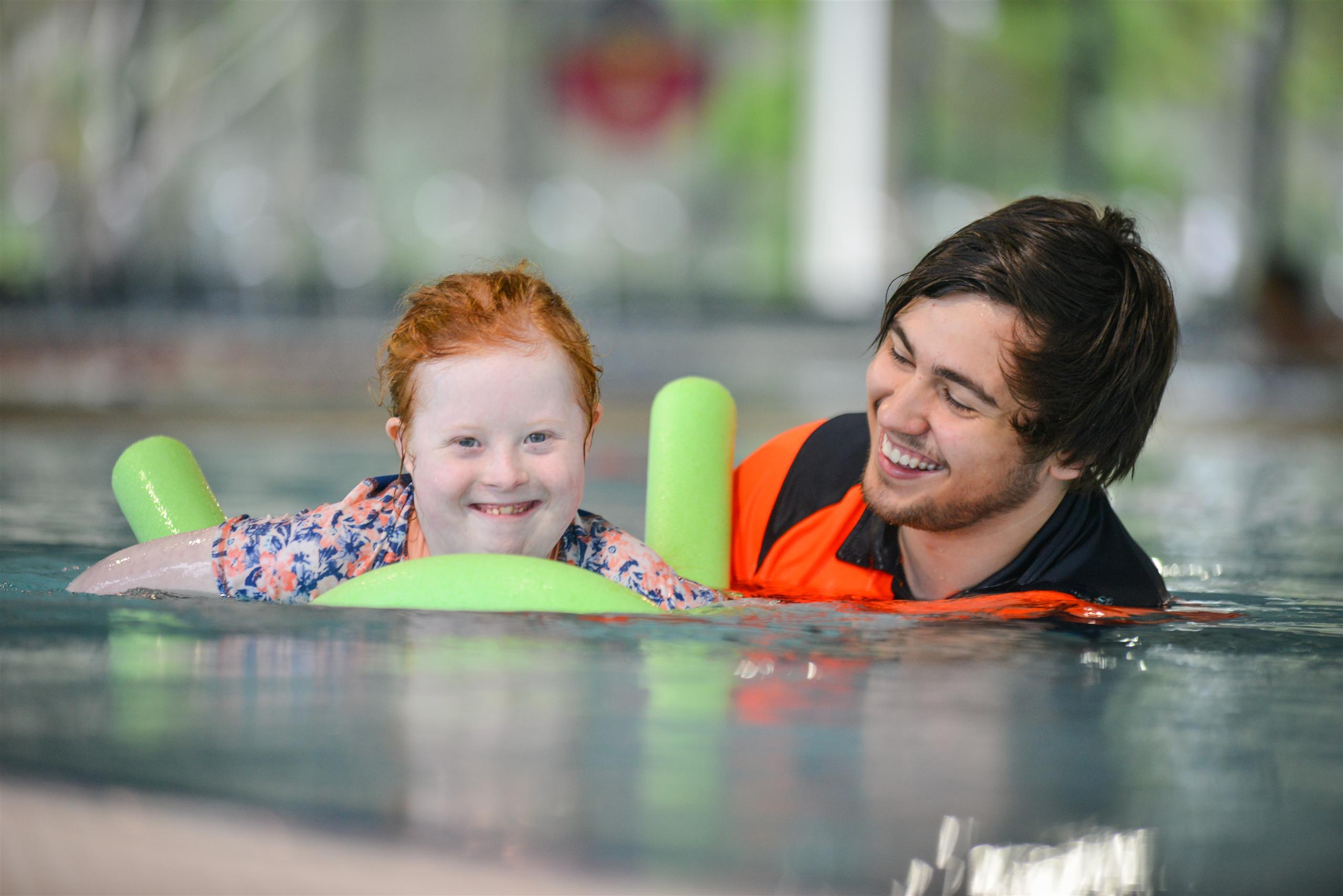 Private adaptive swimming session for a child with a swimming instructor